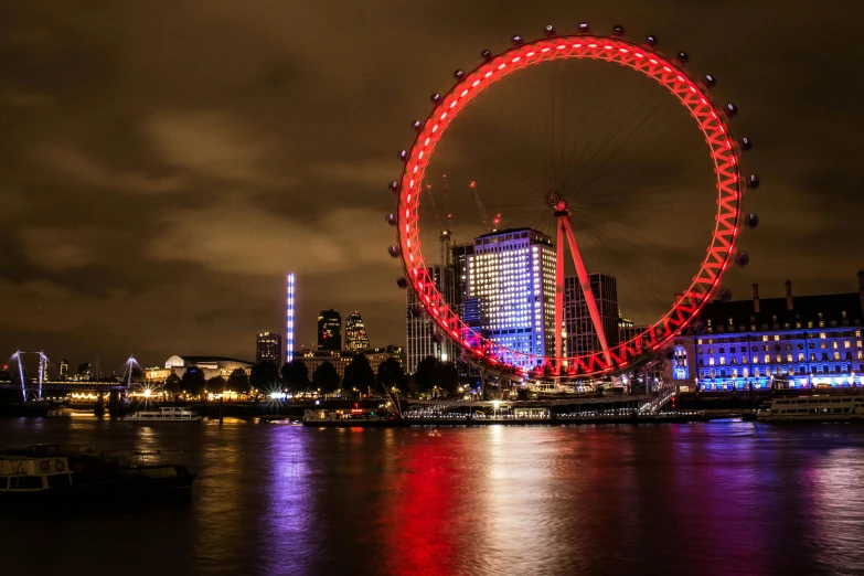 the large ferris wheel is lit up for people to see it