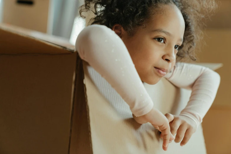 a small girl posing with her arm behind her head