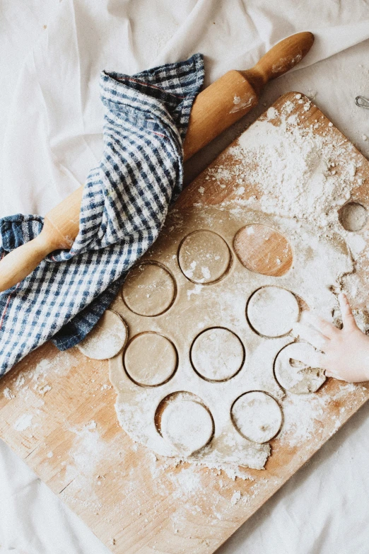 a person is preparing muffins on a table