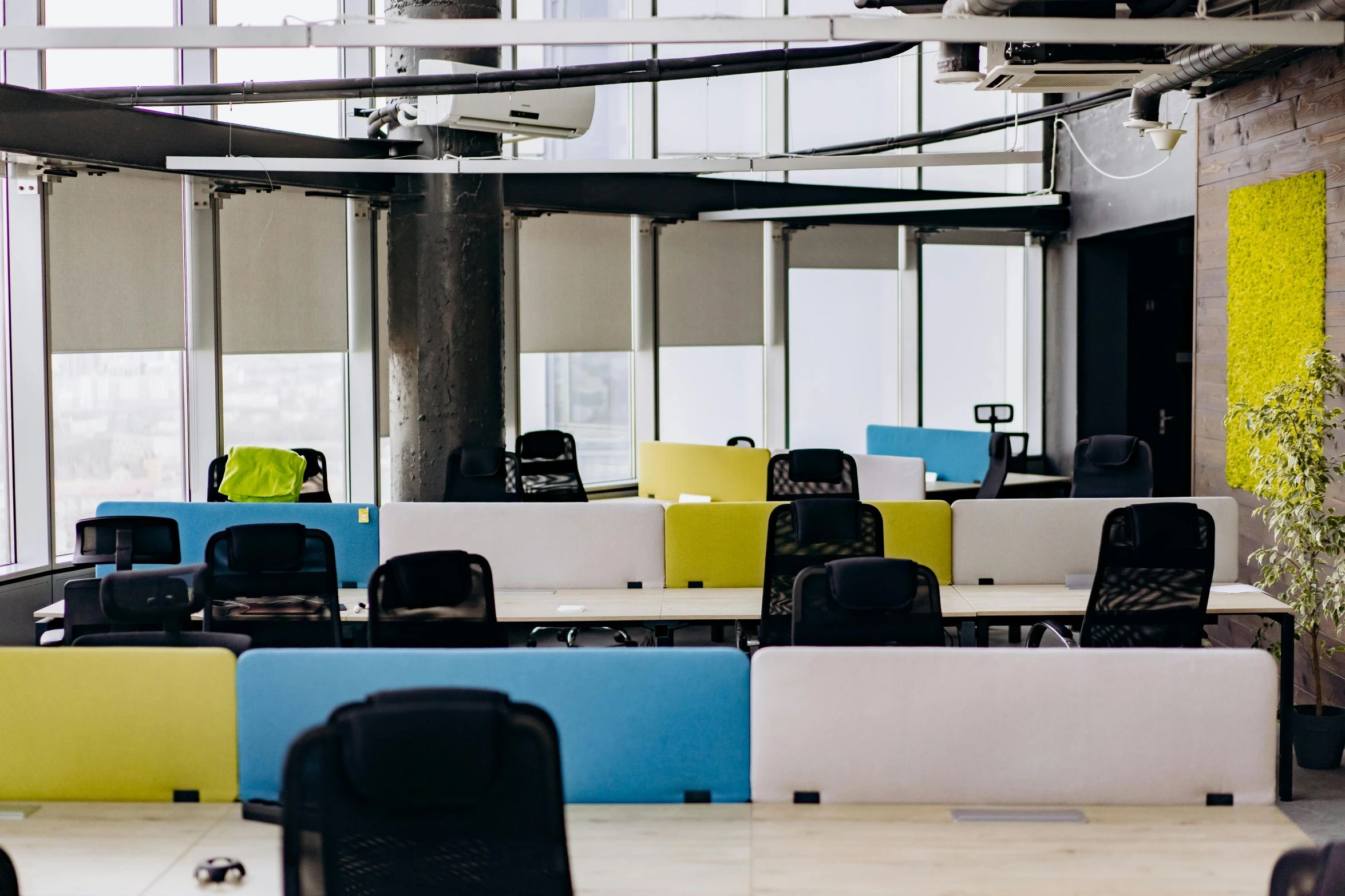 an empty open room filled with lots of cubicles