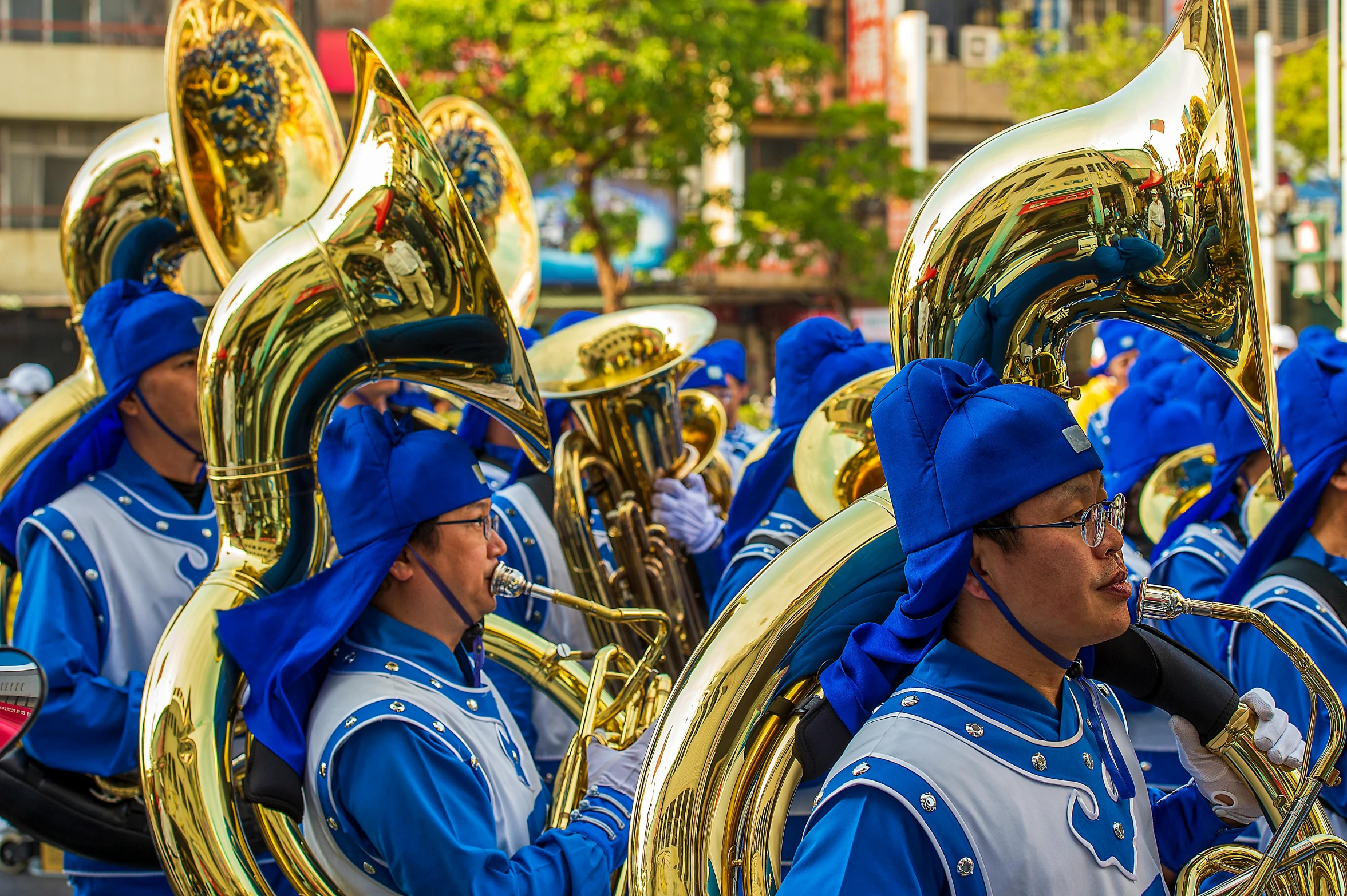 a marching band is dressed in blue and gold uniforms