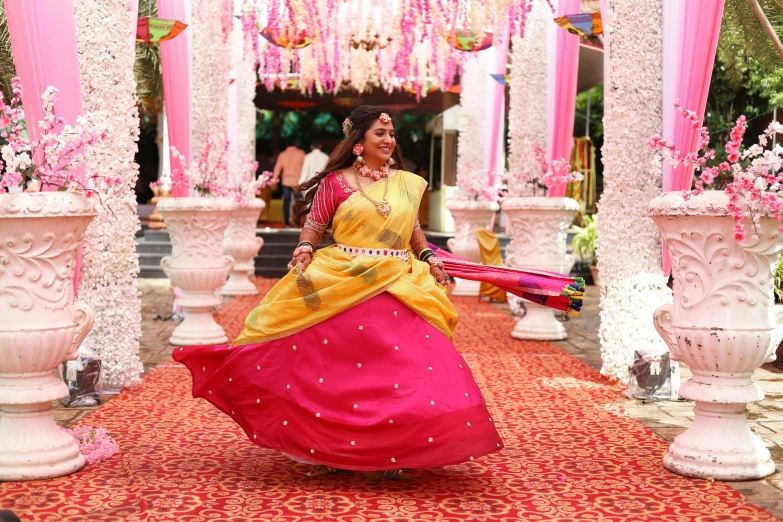 a woman wearing a colorful and fancy wedding gown