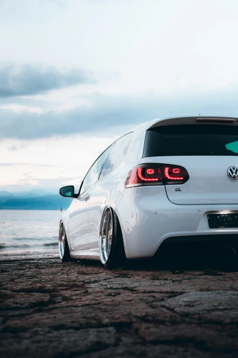 the rear end of a white volkswagen golf