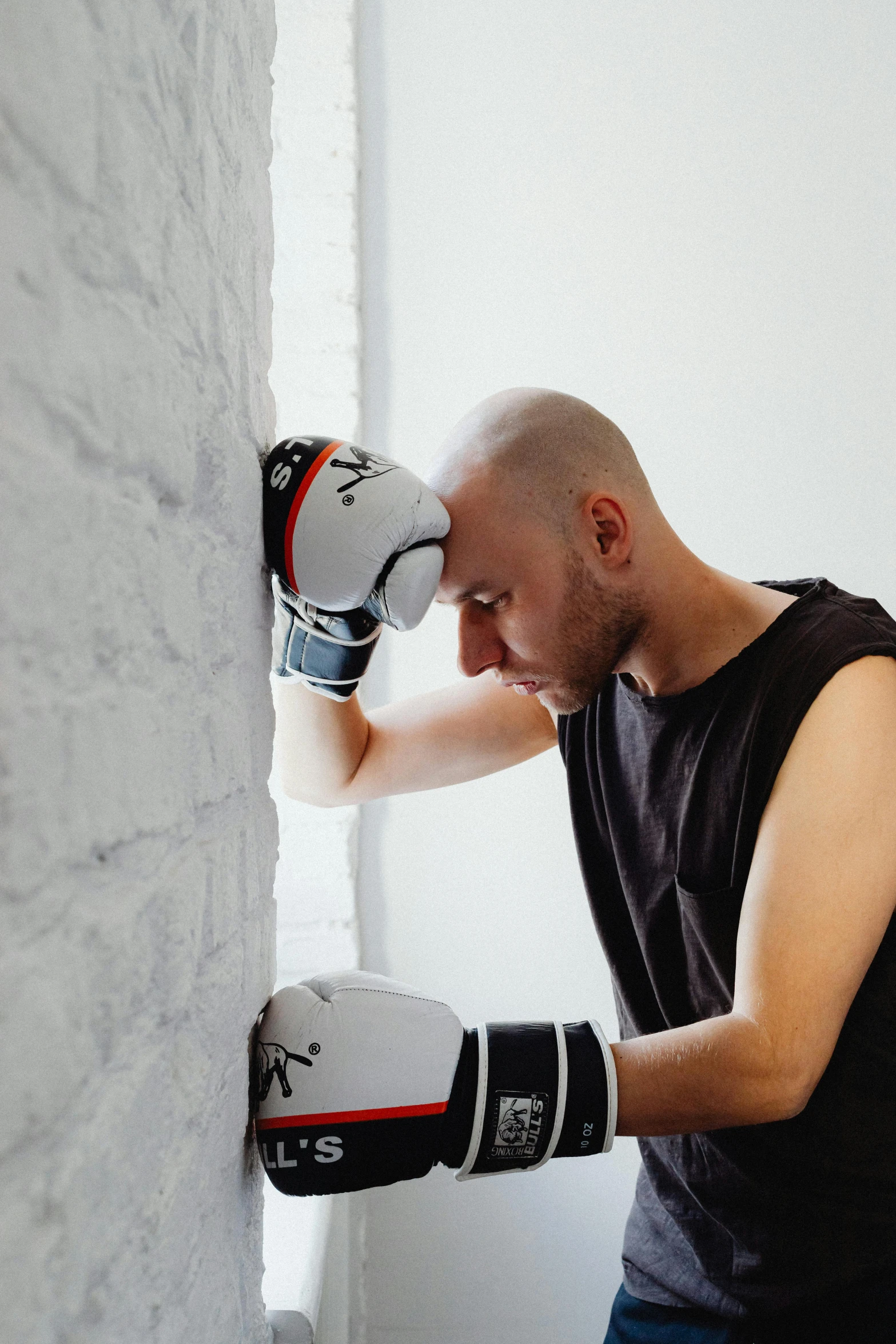 a man in gloves with his hands on the top of a boxing glove