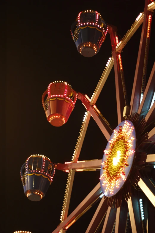 a ferris wheel with some lights on in a park at night