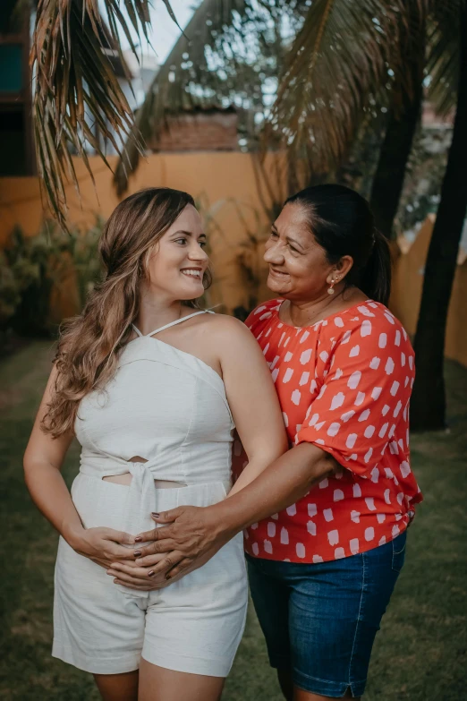 a pregnant woman and  pose together