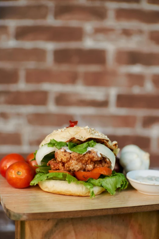 chicken sandwich sitting on top of a  board