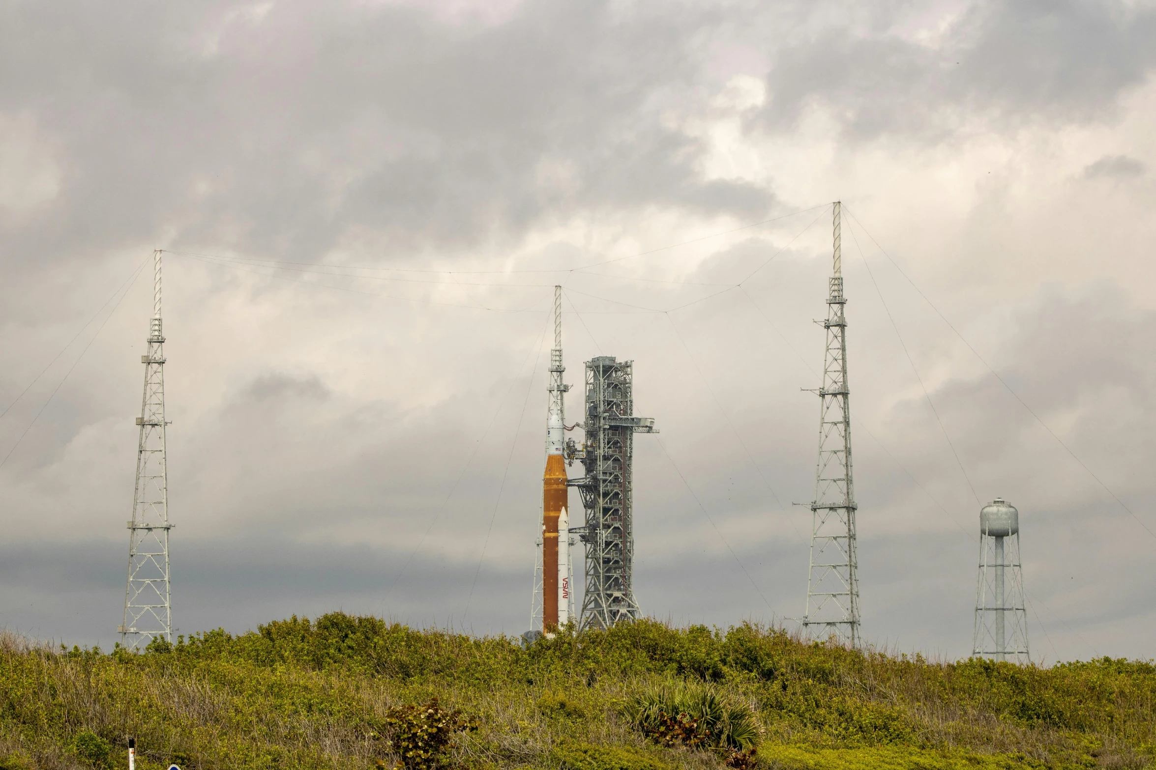 a few television towers and radio towers on a hill