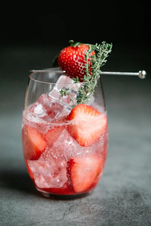 a clear glass with strawberries inside of it