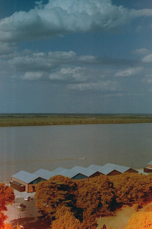 view over the lake towards a large white building with a flag