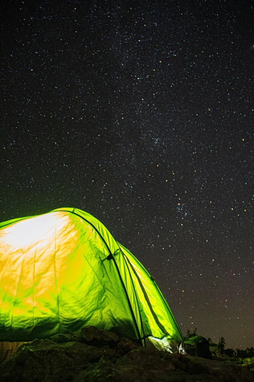 the illuminated tent is visible in the night sky