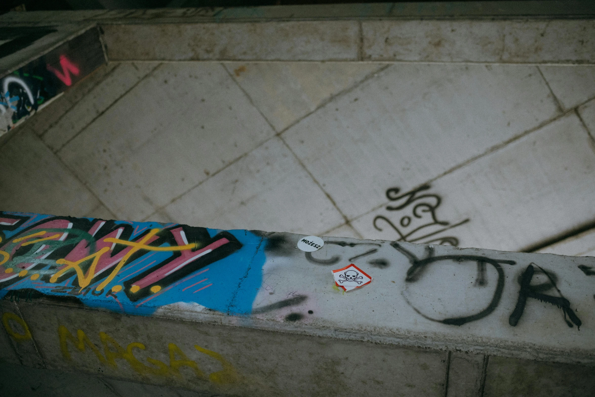 graffiti is written on the side of an old concrete toilet