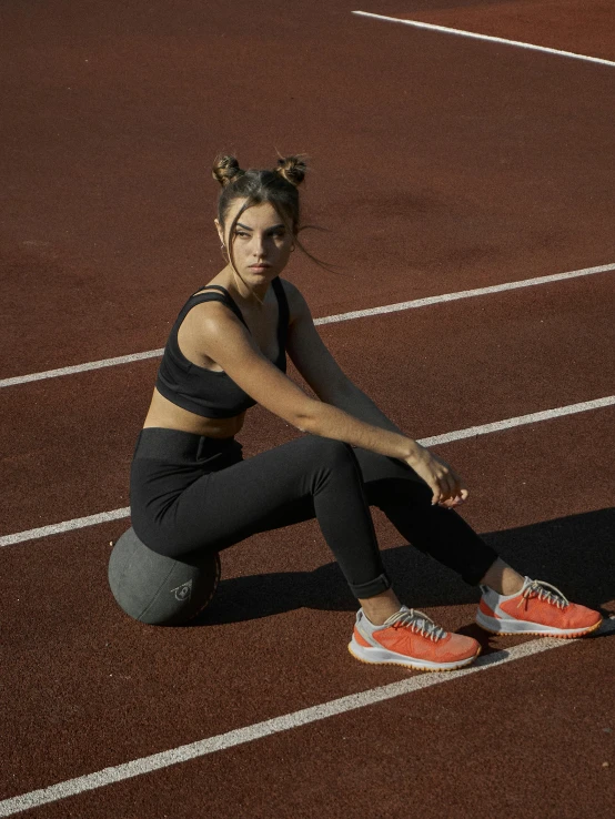 a woman is crouching down on a tennis court