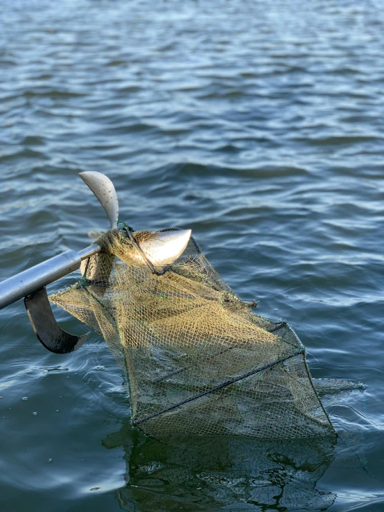 an old fishing net is laying in a lake