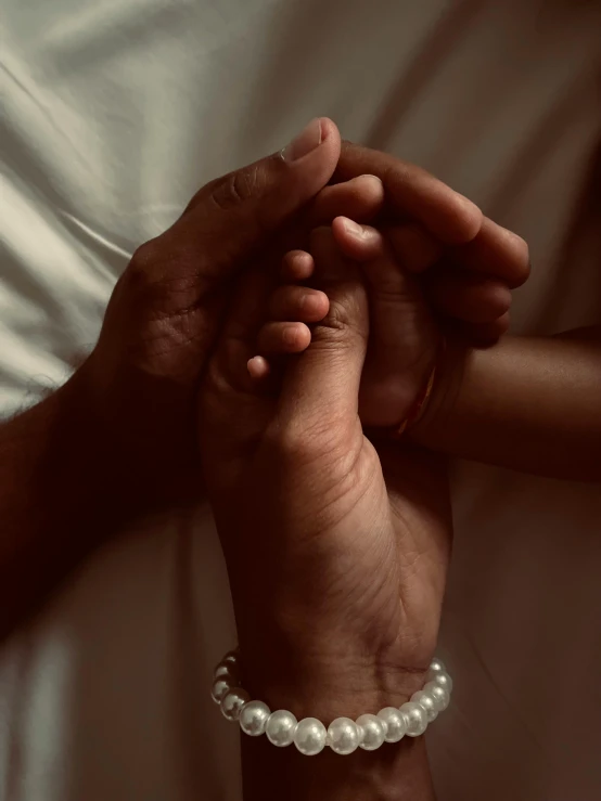 the two hands are holding each other in prayer