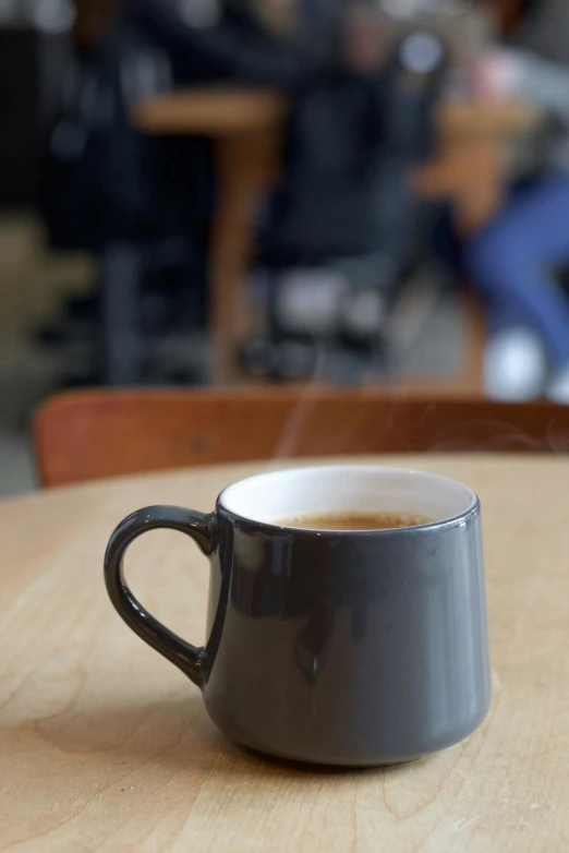 a coffee cup that is sitting on top of a table