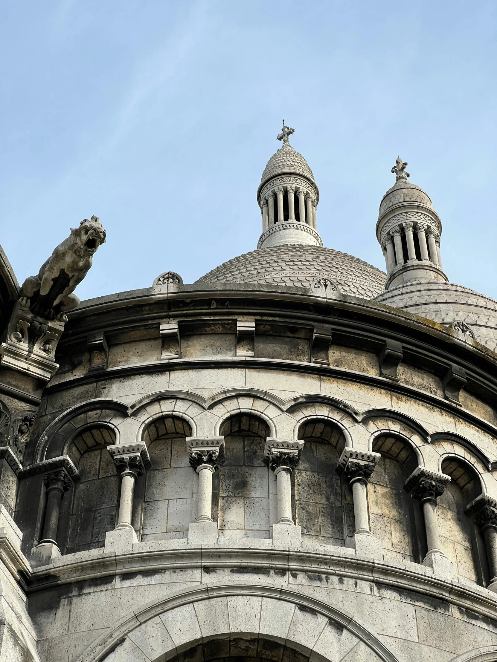 a very old, gray - toned building with some nice dome tops