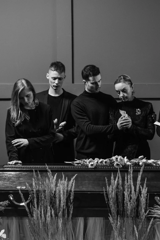 four people standing on a stage holding remote controls