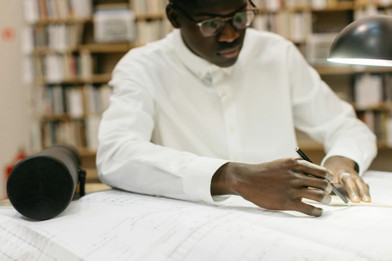 a man that is sitting at a desk