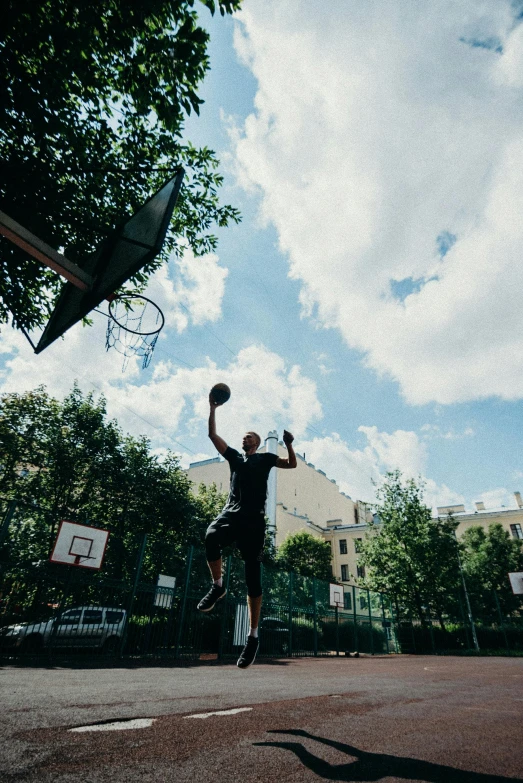 a man playing basketball in the middle of the road
