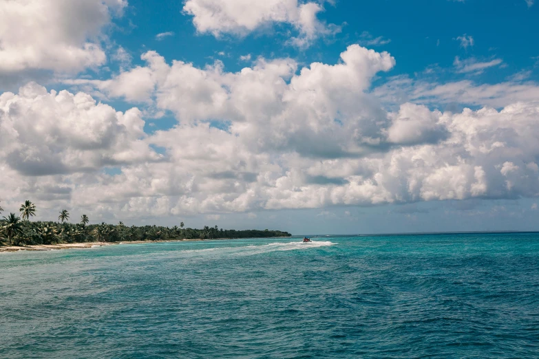 the water of an ocean with clouds and water skiis