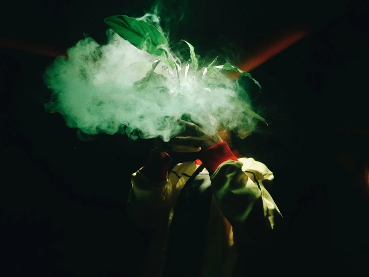 the green smoke is rising from a person's arm