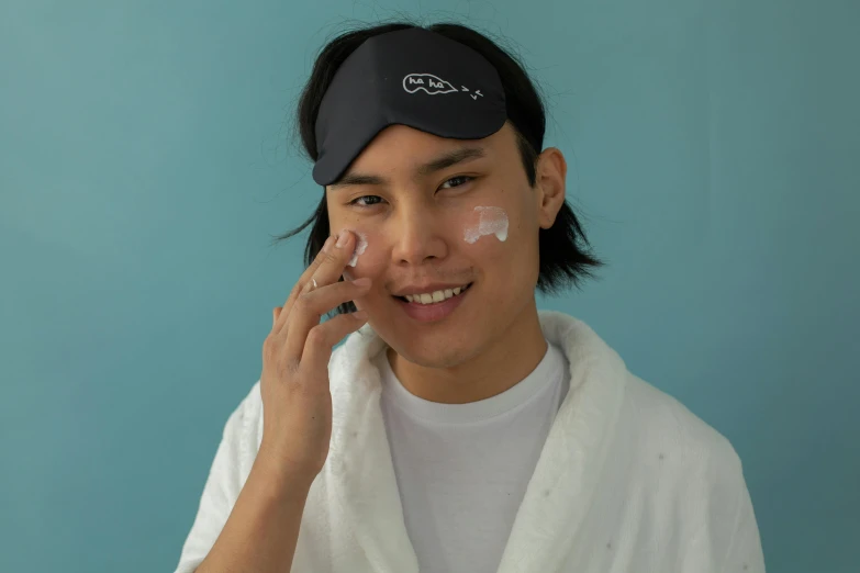 a guy poses with his face covered with a scrub