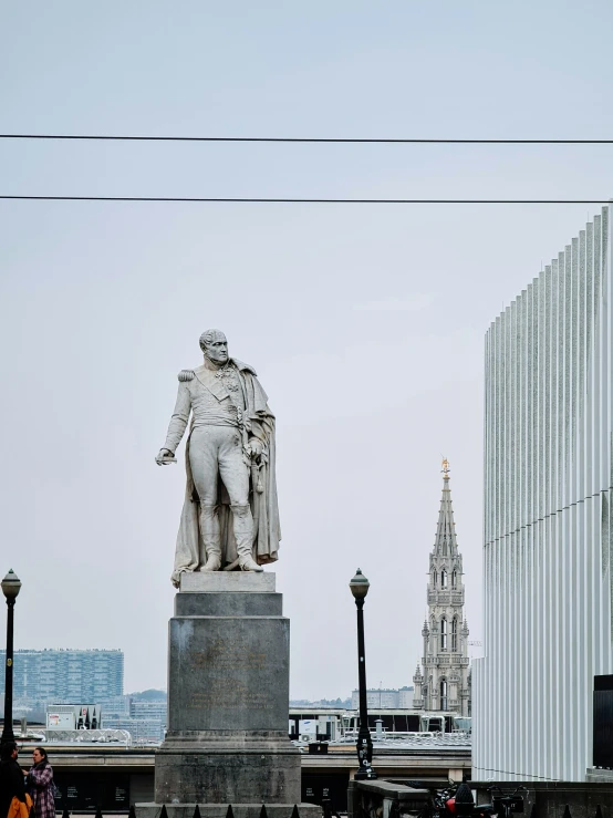 a statue stands in the middle of a city square