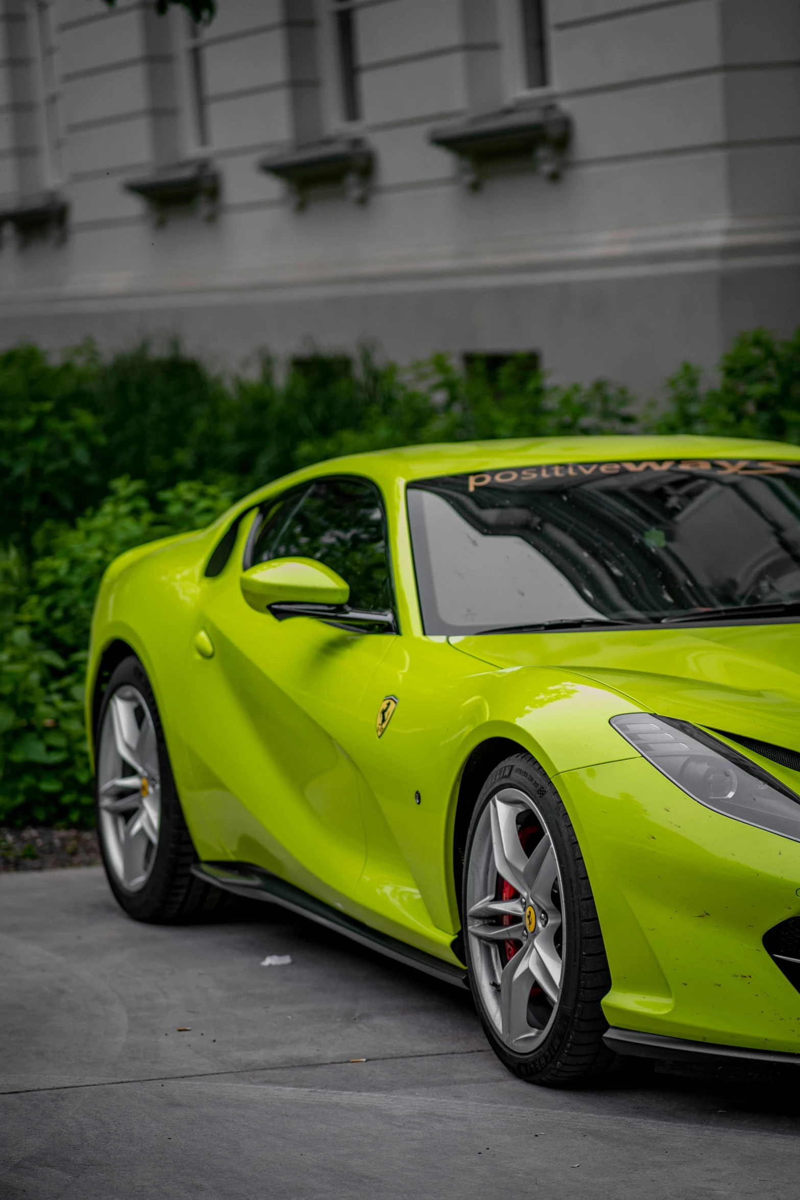 a yellow sports car parked in front of a building