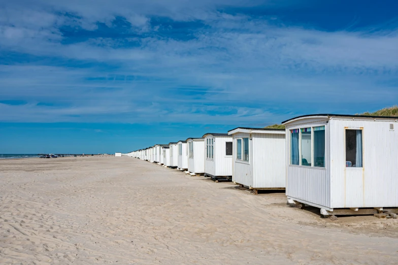 small white cabins lined up on the beach