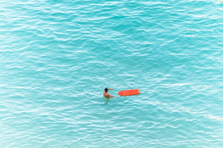 the man is swimming with his swim board