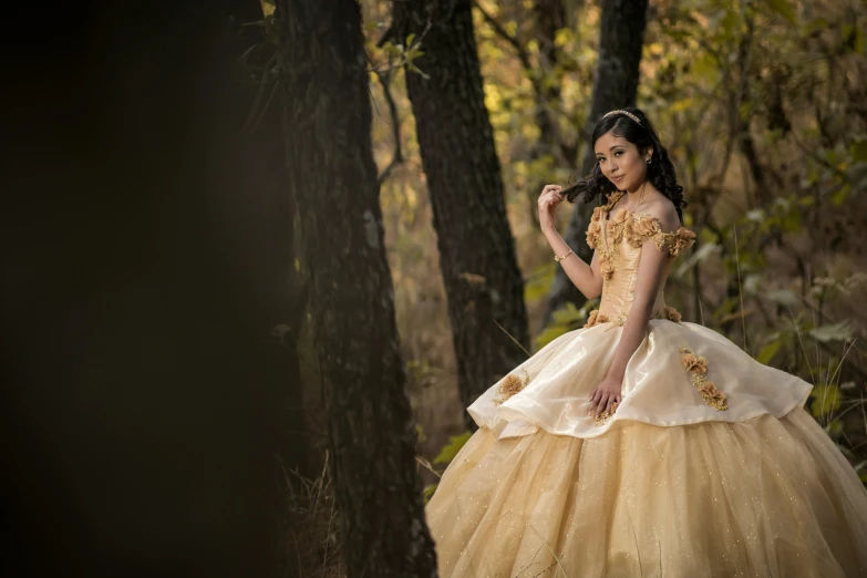 a woman standing in a forest next to a tree