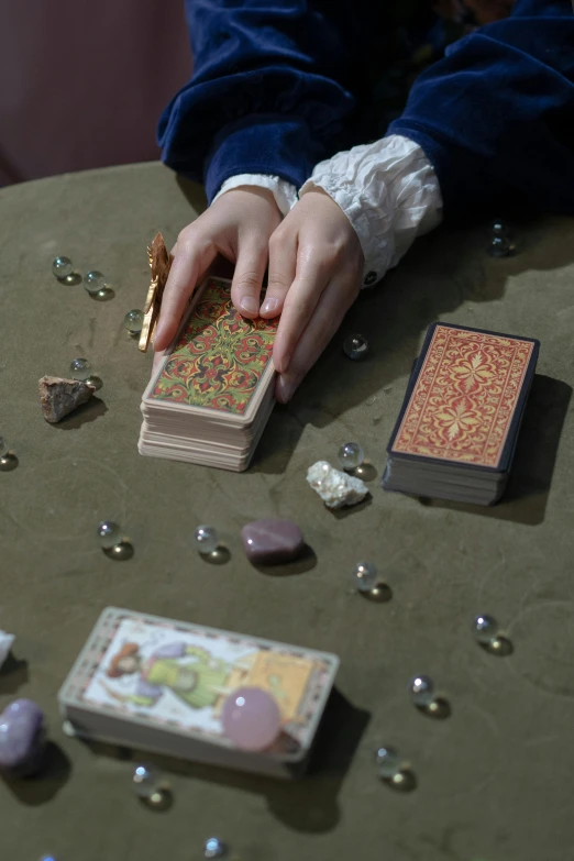 a woman in blue sweater holding some cards