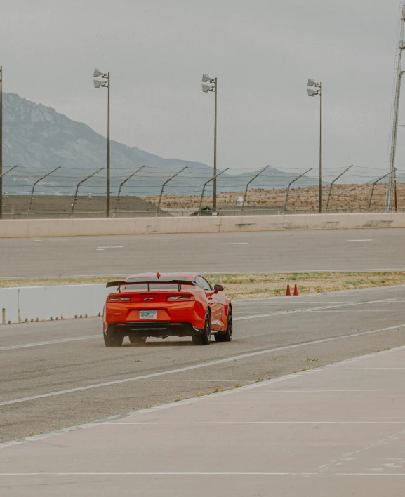 red sports car driving on the track during an event