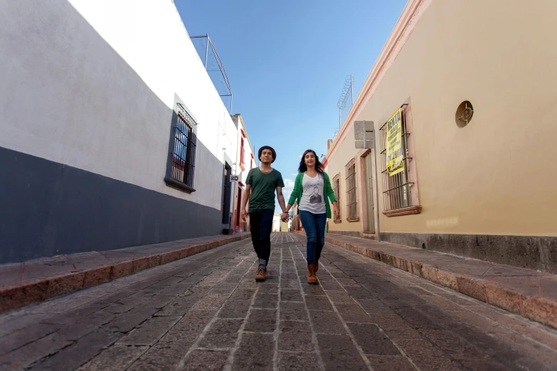 a couple walking down the street on a clear day