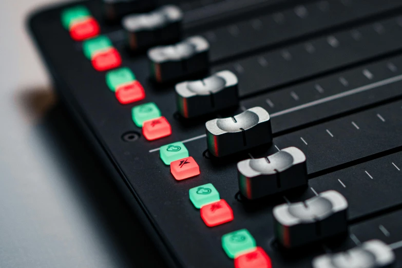 a mixing board has many ons in red and green