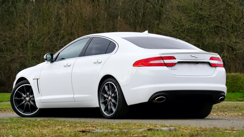 a white sport car is parked on the road