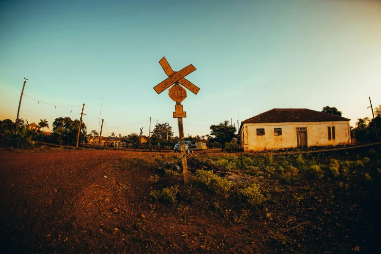 a wooden sign sitting next to a white building