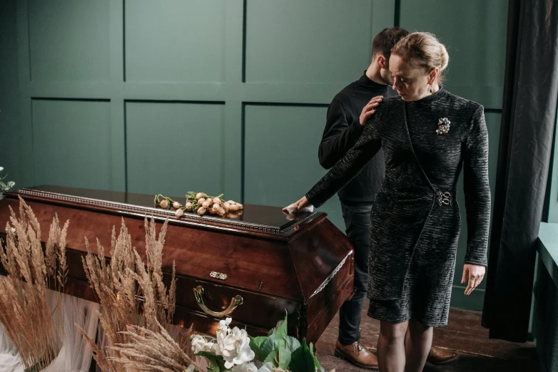 the couple is holding an old fashioned suitcase near a table with flowers