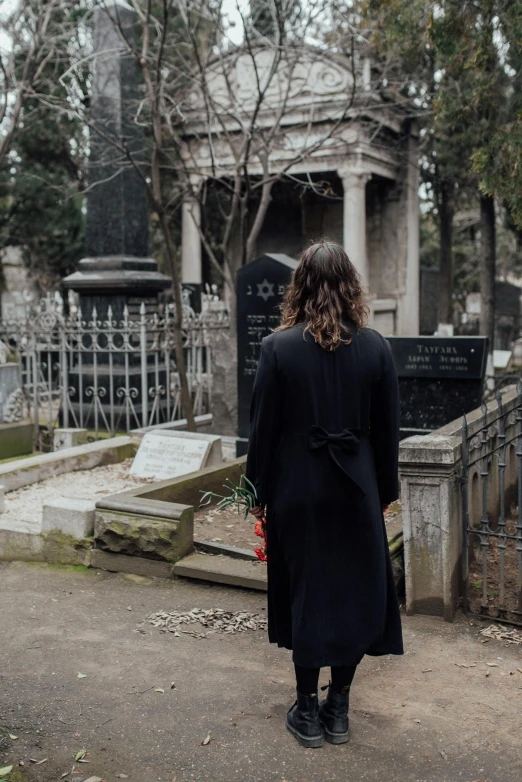 a woman walking down a road while carrying flowers