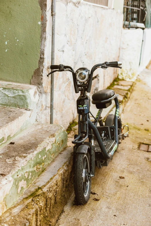 the motorcycle is parked in front of the stone building