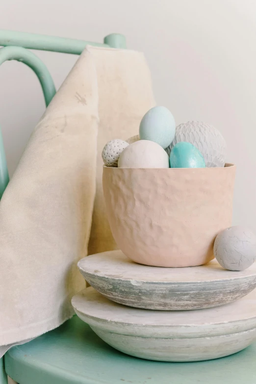 a white bowl filled with blue and white eggs