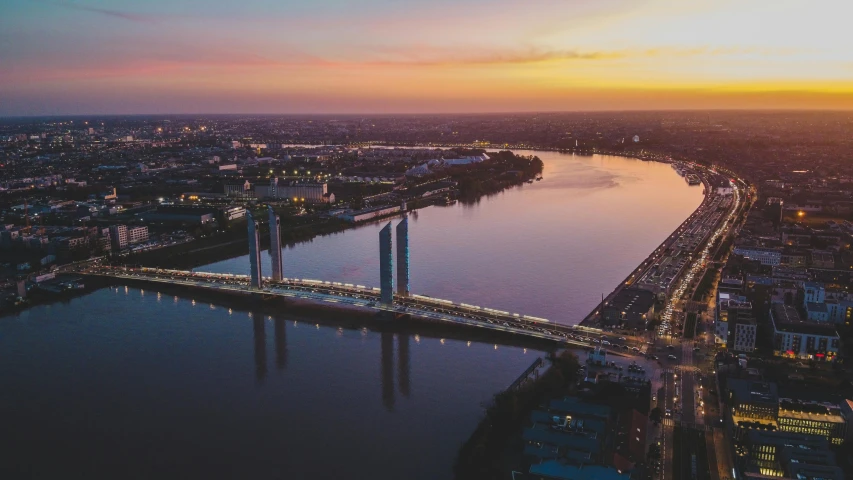 a bridge over water near a city at night