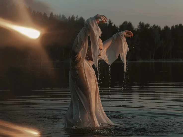 a person in a white dress standing in the water