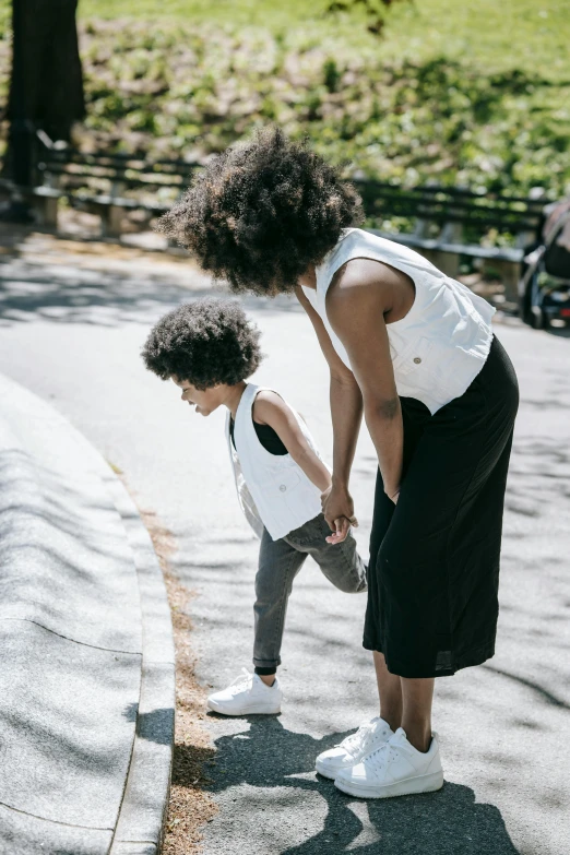 an older woman and her young son standing in a park