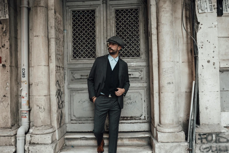 a man in a suit leaning on a door