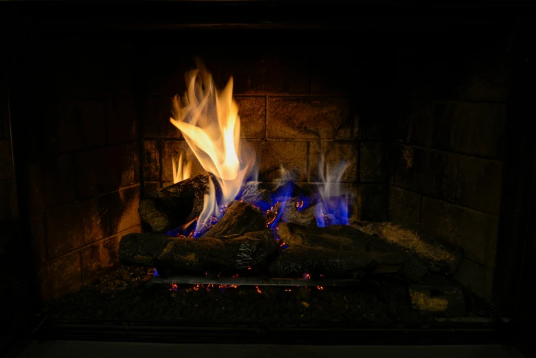 the fire is glowing brightly on a fireplace