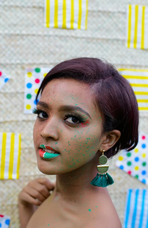 an african woman with green glitter on her face