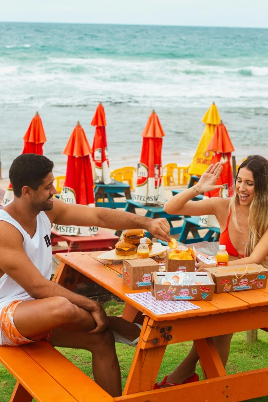 the young man and woman are sitting on the table