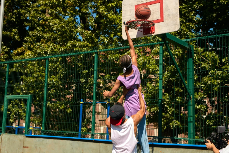 the boys are playing basketball in their court